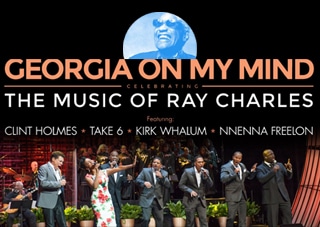 The stars of Georgia on my mind are on stage singing and performing. Above them is text naming the acts of the show and it's title. Above the text, an image of Ray Charles sits proudly above the performers of the show.